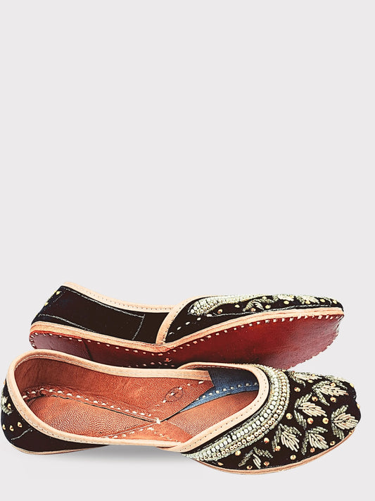 Pair of traditional embroidered shoes on a white background
